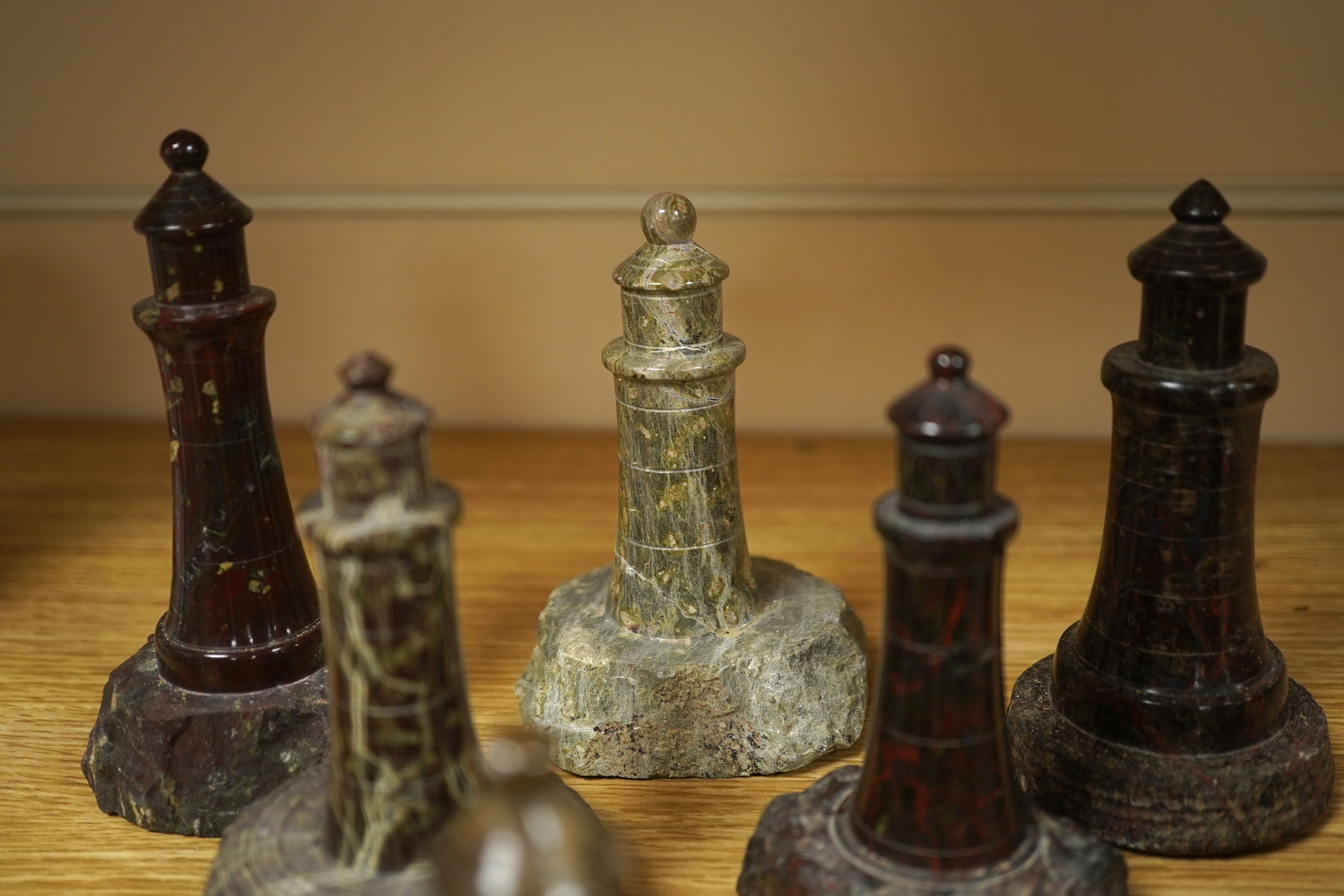 A collection of Cornish serpentine stone carved lighthouses, tallest 13cm high